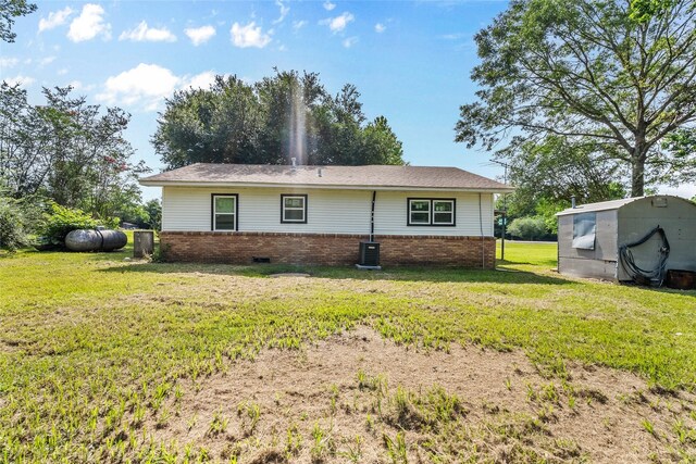 7650 US Highway 69 S, Woodville, TX 75979 - back of house featuring brick siding and a yard
