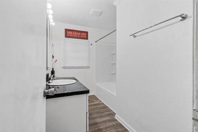 7650 US Highway 69 S, Woodville, TX 75979 - full bathroom featuring vanity, tub / shower combination, ornamental molding, and wood finished floors