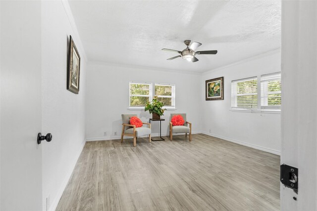 7650 US Highway 69 S, Woodville, TX 75979 - living area with ornamental molding, healthy amount of natural light, light wood-style floors, and a ceiling fan