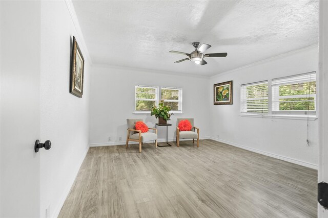 7650 US Highway 69 S, Woodville, TX 75979 - living area with ornamental molding, light wood finished floors, ceiling fan, and a textured ceiling