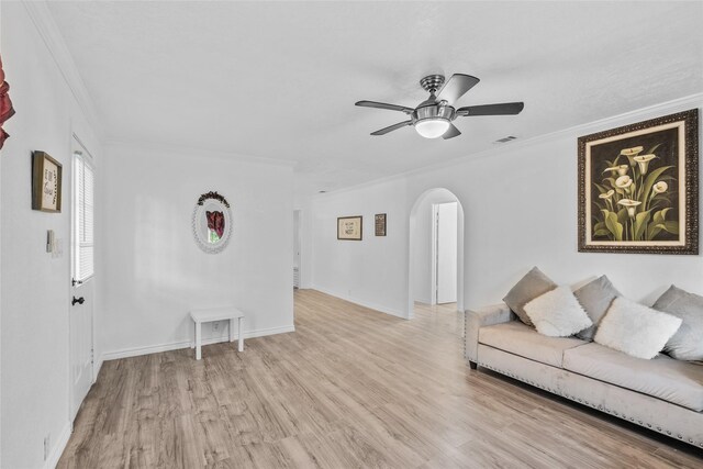 7650 US Highway 69 S, Woodville, TX 75979 - living room featuring arched walkways, crown molding, light wood-type flooring, and ceiling fan