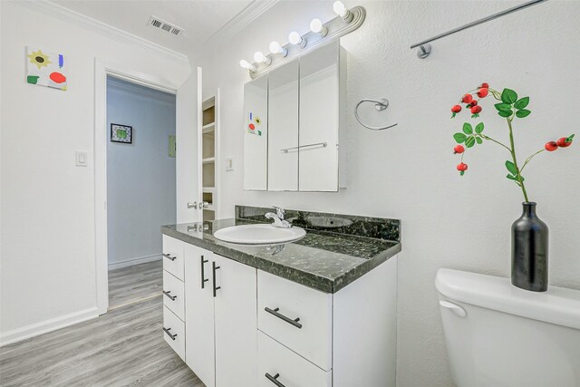 7650 US Highway 69 S, Woodville, TX 75979 - bathroom with vanity, ornamental molding, and wood finished floors