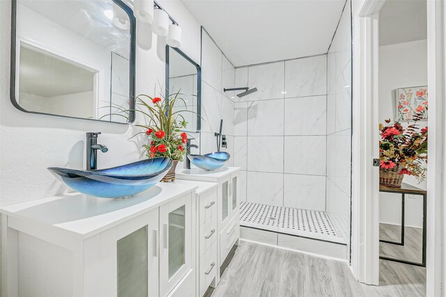 7650 US Highway 69 S, Woodville, TX 75979 - full bath featuring tiled shower, vanity, and wood finished floors