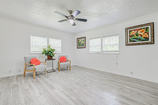 7650 US Highway 69 S, Woodville, TX 75979 - sitting room with crown molding, light wood-type flooring, a textured ceiling, and ceiling fan