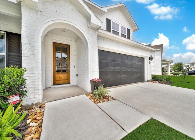2331 Hagerman Rd, Conroe, TX 77384 - property entrance featuring brick siding, driveway, and an attached garage