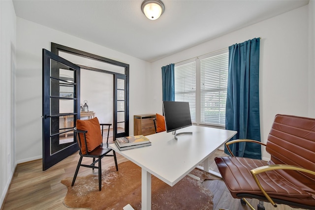 2331 Hagerman Rd, Conroe, TX 77384 - home office with baseboards and light wood-style floors