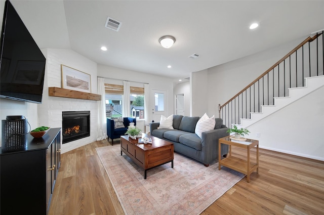 2331 Hagerman Rd, Conroe, TX 77384 - living room with a fireplace, light wood-style flooring, stairway, and recessed lighting