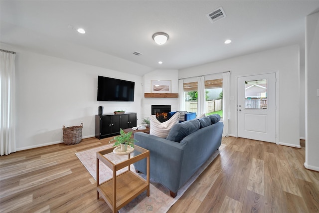 2331 Hagerman Rd, Conroe, TX 77384 - living area featuring a glass covered fireplace, light wood-style floors, baseboards, and recessed lighting