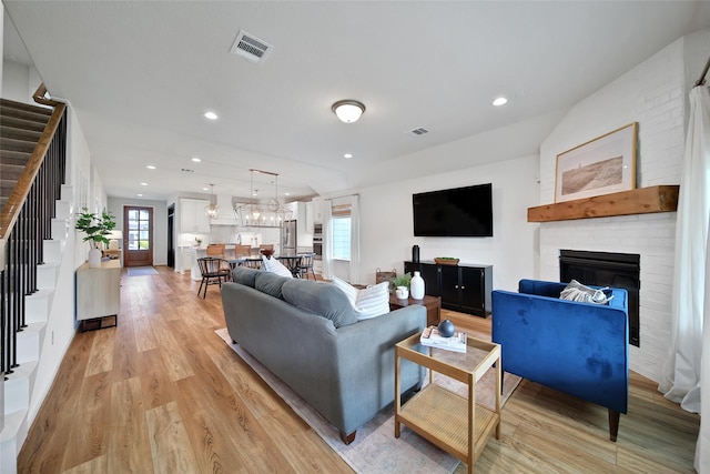 2331 Hagerman Rd, Conroe, TX 77384 - living room with stairway, light wood-style flooring, a fireplace, and recessed lighting