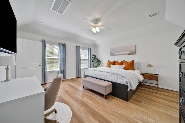 2331 Hagerman Rd, Conroe, TX 77384 - bedroom with light wood-style floors, baseboards, ceiling fan, a tray ceiling, and lofted ceiling