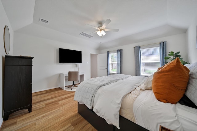 2331 Hagerman Rd, Conroe, TX 77384 - bedroom with light wood finished floors, ceiling fan, baseboards, and a tray ceiling