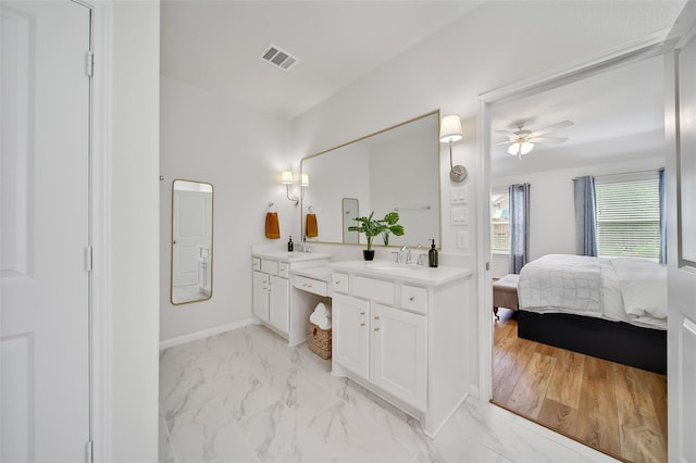 2331 Hagerman Rd, Conroe, TX 77384 - full bathroom featuring double vanity, a ceiling fan, ensuite bathroom, marble finish floors, and baseboards