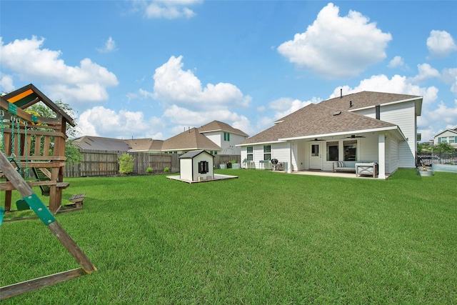 2331 Hagerman Rd, Conroe, TX 77384 - back of house with a ceiling fan, a patio area, a shingled roof, and an outdoor hangout area