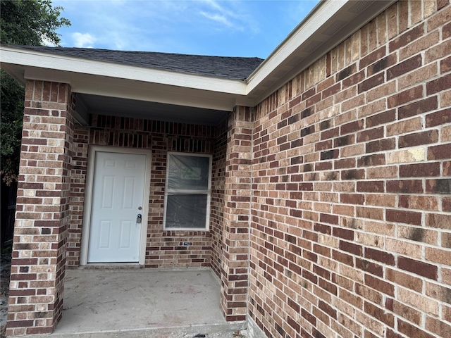 17458 Wigeon Way Dr, Humble, TX 77396 - view of exterior entry with brick siding and a shingled roof
