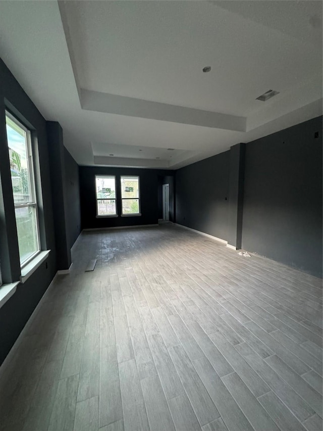 17458 Wigeon Way Dr, Humble, TX 77396 - unfurnished room with a tray ceiling, wood finished floors, and baseboards