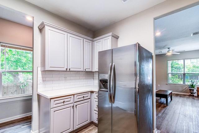 4403 2nd St, Bacliff, TX 77518 - kitchen featuring stainless steel refrigerator with ice dispenser, light wood finished floors, light countertops, and baseboards