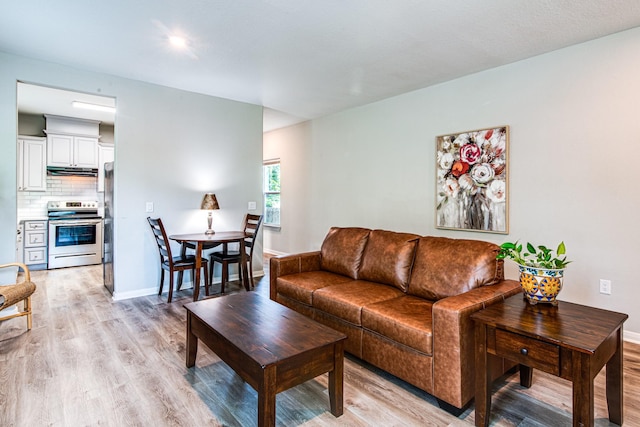 4403 2nd St, Bacliff, TX 77518 - living room with light wood-style flooring and baseboards