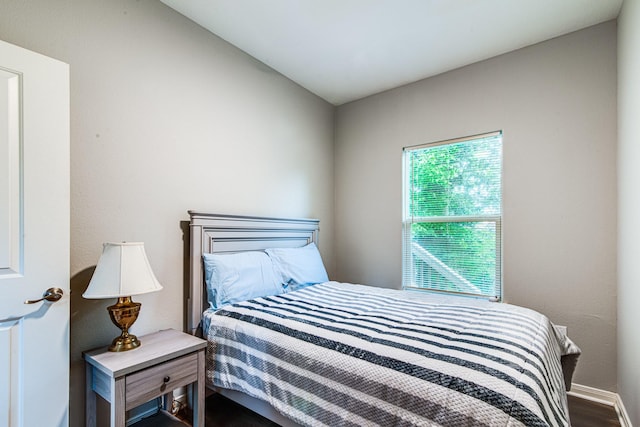 4403 2nd St, Bacliff, TX 77518 - bedroom featuring baseboards and dark wood-type flooring