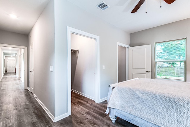 4403 2nd St, Bacliff, TX 77518 - bedroom with a spacious closet, dark wood-style flooring, a closet, baseboards, and a ceiling fan