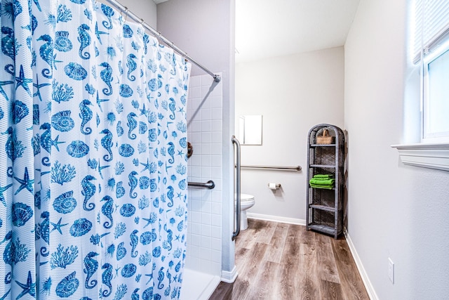 4403 2nd St, Bacliff, TX 77518 - full bath with toilet, wood finished floors, a shower with curtain, and baseboards