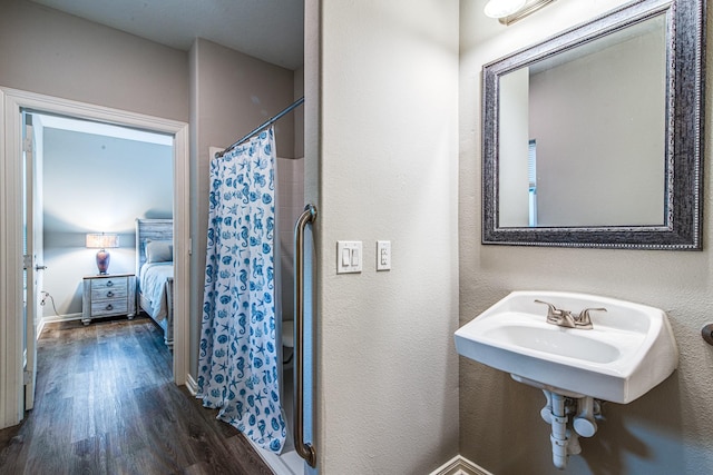 4403 2nd St, Bacliff, TX 77518 - ensuite bathroom featuring wood finished floors and curtained shower