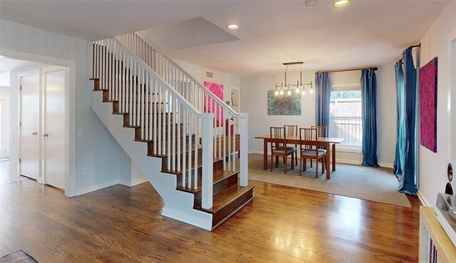 2737 Werlein Ave, Houston, TX 77005 - stairway featuring wood finished floors, baseboards, recessed lighting, and a chandelier