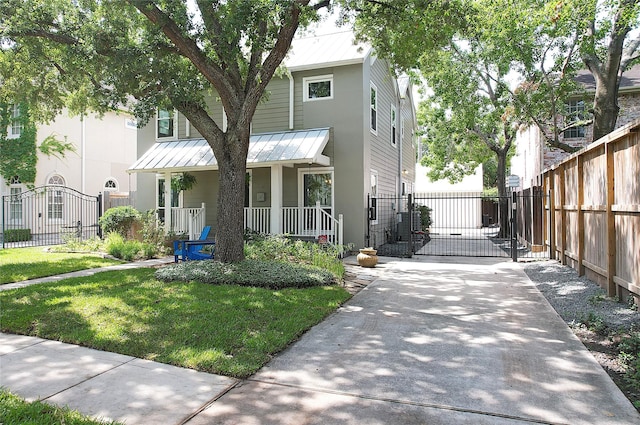 2737 Werlein Ave, Houston, TX 77005 - view of front of property with a gate, covered porch, metal roof, and a standing seam roof