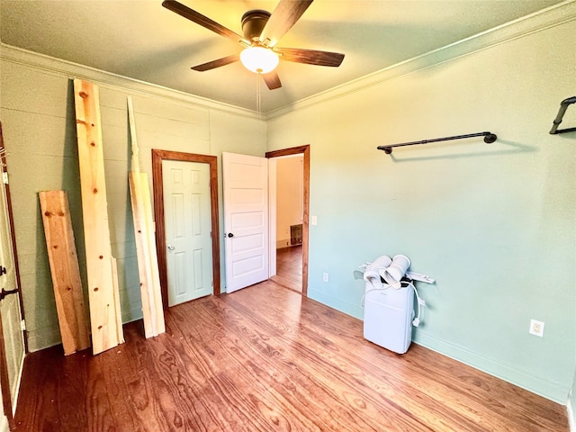 1317 Church St, Galveston, TX 77550 - unfurnished bedroom featuring ornamental molding, wood finished floors, and a ceiling fan