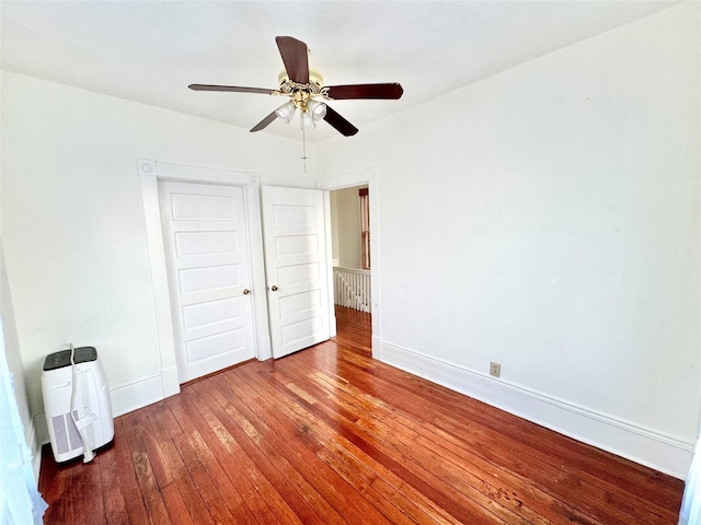 1317 Church St, Galveston, TX 77550 - unfurnished bedroom with wood-type flooring, baseboards, and a ceiling fan