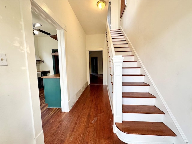 1317 Church St, Galveston, TX 77550 - stairway with wood finished floors, a ceiling fan, and baseboards