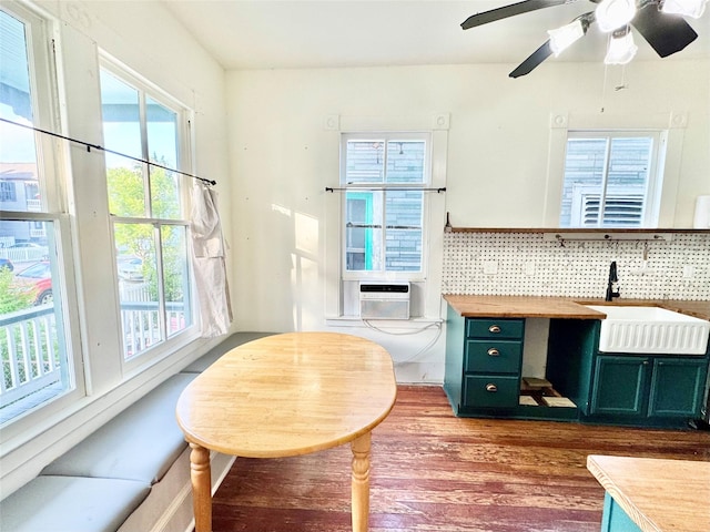 1317 Church St, Galveston, TX 77550 - kitchen with green cabinets, a sink, plenty of natural light, and wood finished floors