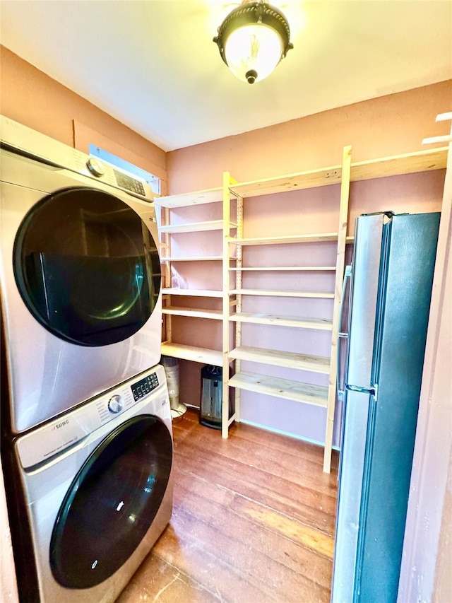 1317 Church St, Galveston, TX 77550 - laundry area featuring stacked washer and clothes dryer and wood finished floors