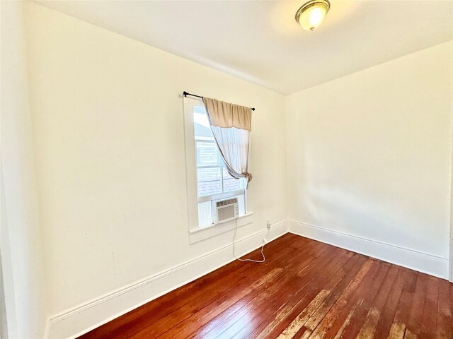 1317 Church St, Galveston, TX 77550 - spare room featuring dark wood-style floors, cooling unit, and baseboards