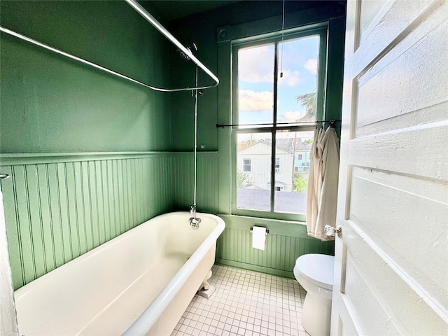1317 Church St, Galveston, TX 77550 - bathroom with a soaking tub, toilet, and tile patterned flooring