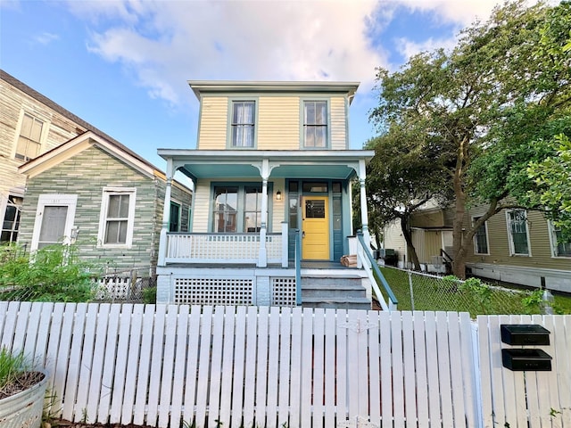 1317 Church St, Galveston, TX 77550 - view of front of house featuring covered porch and a fenced front yard