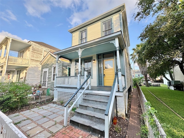 1317 Church St, Galveston, TX 77550 - view of front of home featuring covered porch and a front lawn