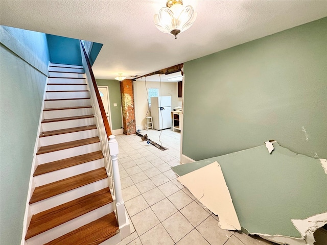 1317 Church St, Galveston, TX 77550 - staircase with tile patterned flooring and a textured ceiling