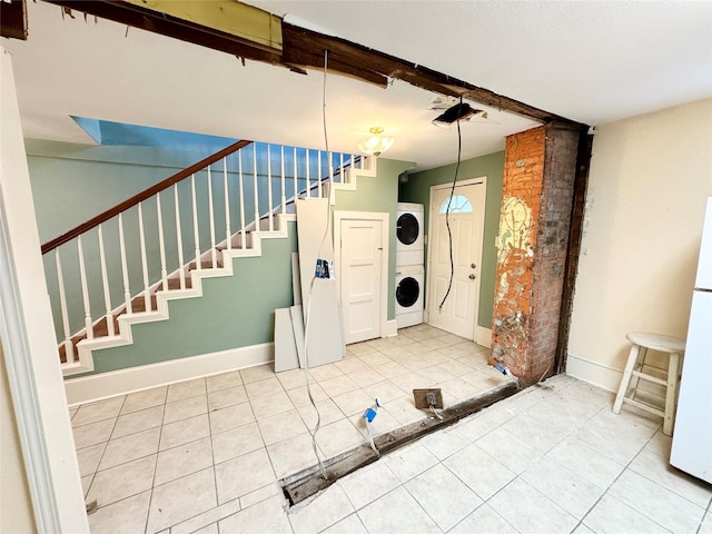 1317 Church St, Galveston, TX 77550 - tiled foyer with estacked washer and dryer, baseboards, and stairs