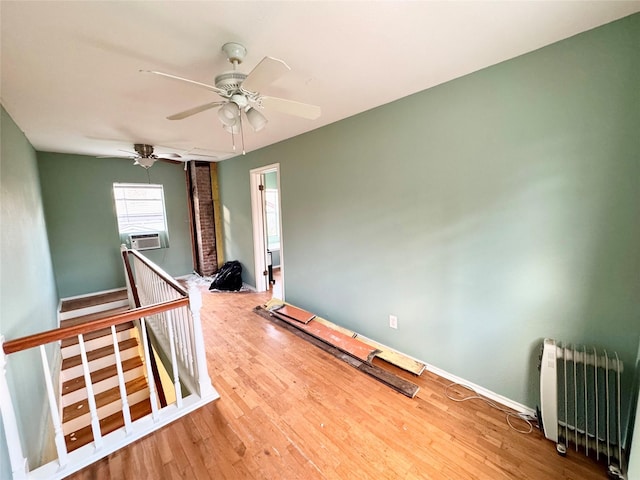 1317 Church St, Galveston, TX 77550 - unfurnished room with radiator heating unit, a ceiling fan, wood finished floors, and cooling unit