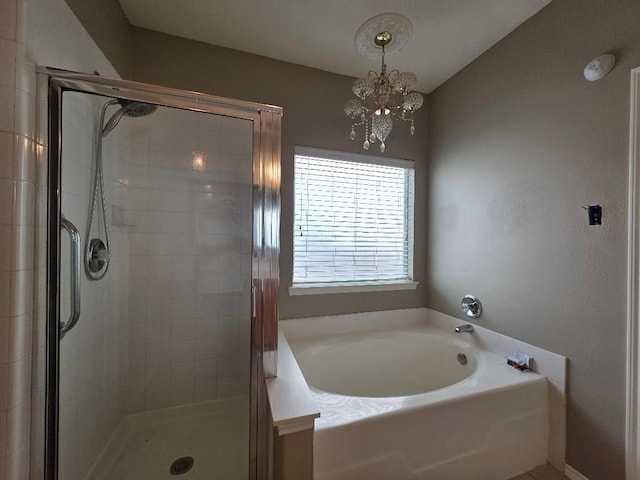 19518 Grand Colony Ct, Katy, TX 77449 - bathroom with a garden tub, a stall shower, and a chandelier