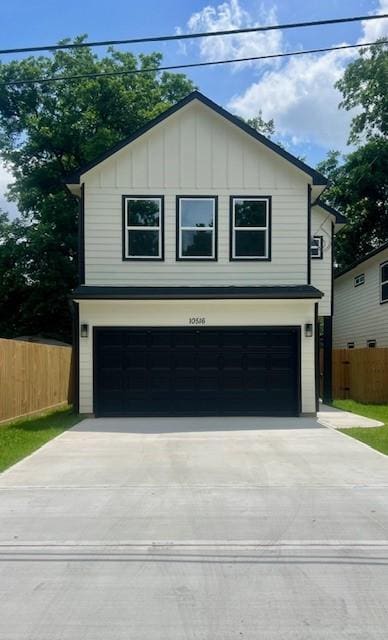 10516 Exeter St, Houston, TX 77093 - view of front of house featuring board and batten siding, an attached garage, and concrete driveway