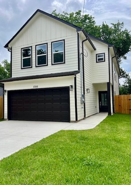 10516 Exeter St, Houston, TX 77093 - view of front facade featuring an attached garage, driveway, and board and batten siding