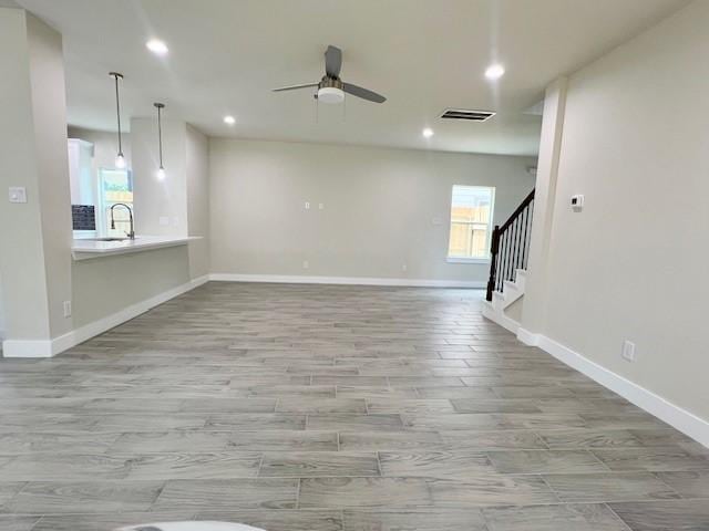 10516 Exeter St, Houston, TX 77093 - empty room with recessed lighting, a ceiling fan, stairway, and light wood-style floors