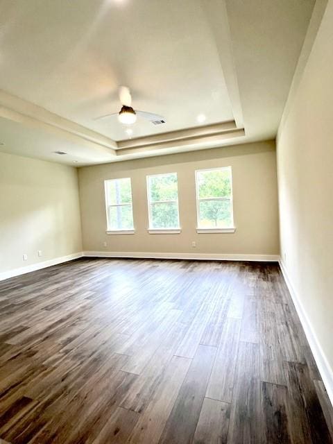 10516 Exeter St, Houston, TX 77093 - empty room featuring a raised ceiling, dark wood finished floors, and a ceiling fan