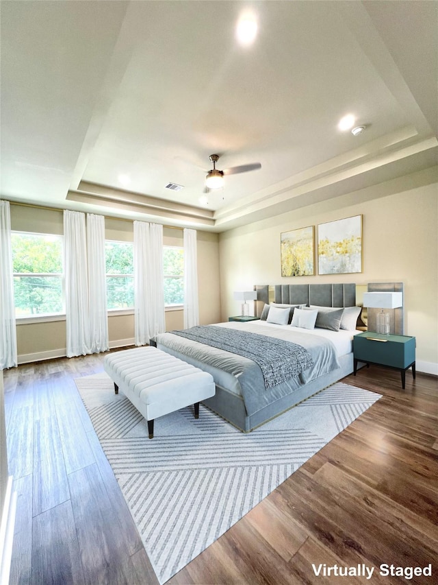 10516 Exeter St, Houston, TX 77093 - bedroom featuring a tray ceiling, wood finished floors, and recessed lighting