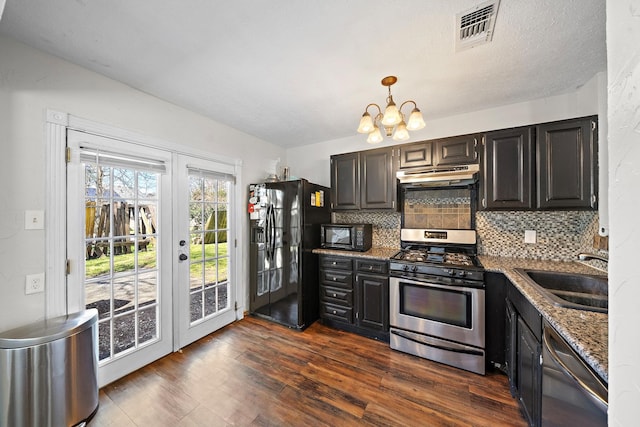22303 Acorn Chase Dr, Spring, TX 77389 - kitchen featuring black appliances, a sink, under cabinet range hood, and tasteful backsplash