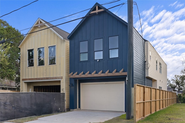 5306 San Juan St, Houston, TX 77020 - view of front of property with board and batten siding, an attached garage, and concrete driveway