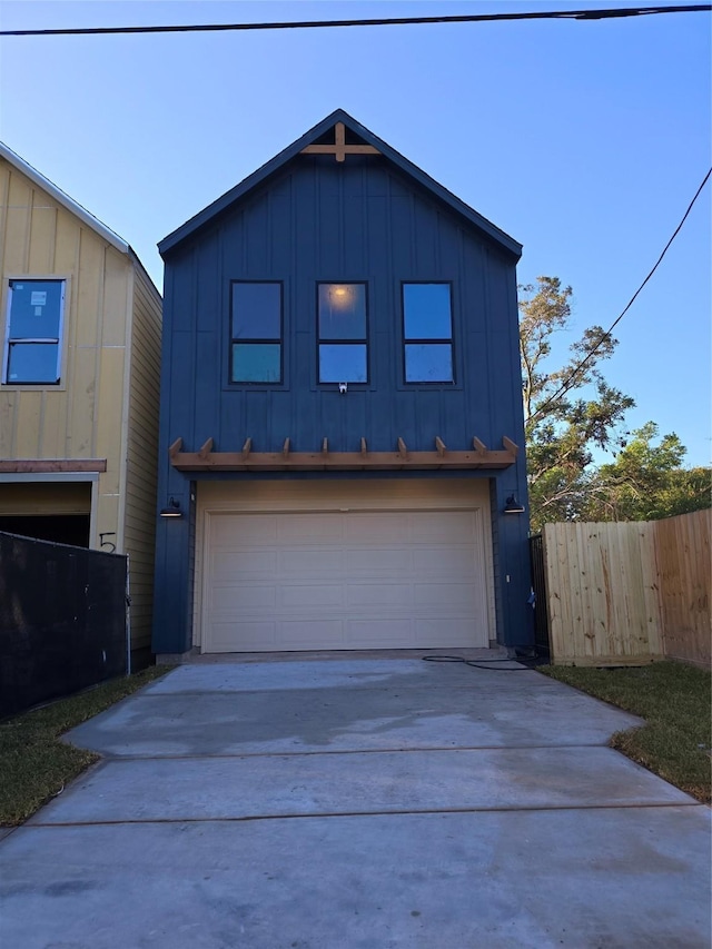 5306 San Juan St, Houston, TX 77020 - view of front of house featuring board and batten siding, driveway, and a garage