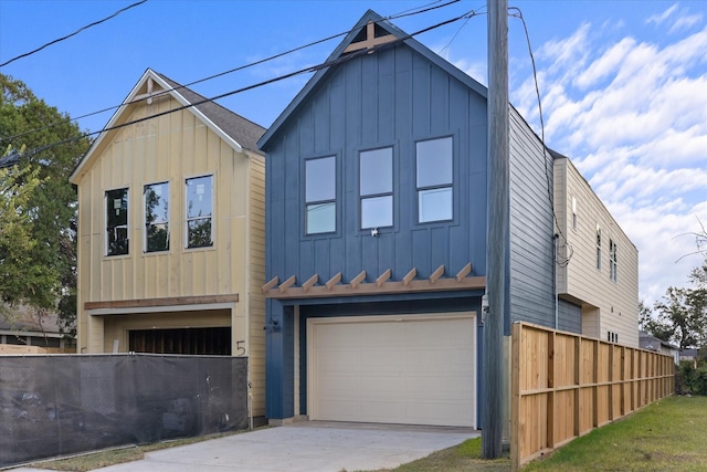 5306 San Juan St, Houston, TX 77020 - view of front of property with board and batten siding, a garage, and driveway