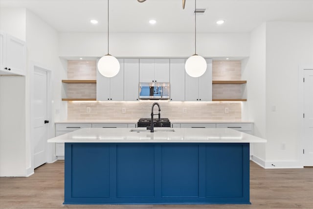5306 San Juan St, Houston, TX 77020 - kitchen featuring open shelves, stainless steel microwave, tasteful backsplash, white cabinetry, and recessed lighting